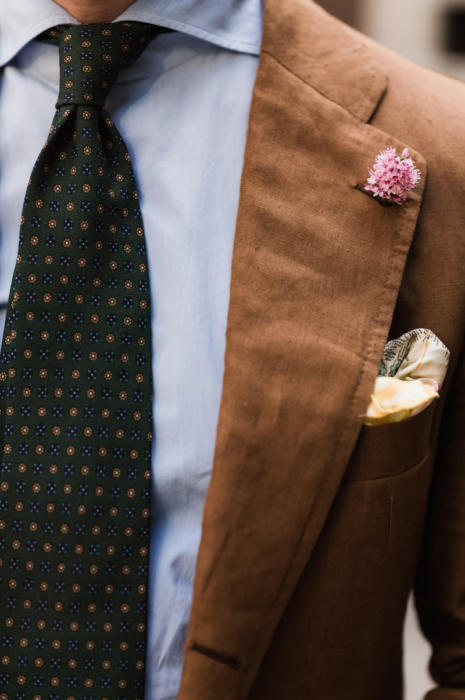 Brown linen suit with pink boutonniere