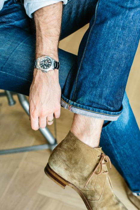 Folded jeans and white shoes. Blue denim pants with footwear. Quality  casual shoes on display. Canvas footwear for women. Stock Photo