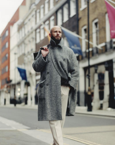 Grey herringbone coat and cream trousers