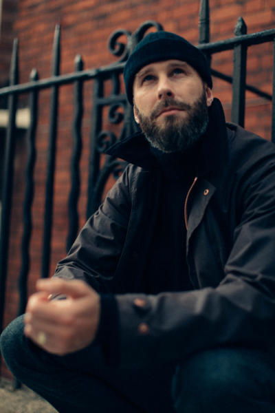 Black roll neck and charcoal flannels